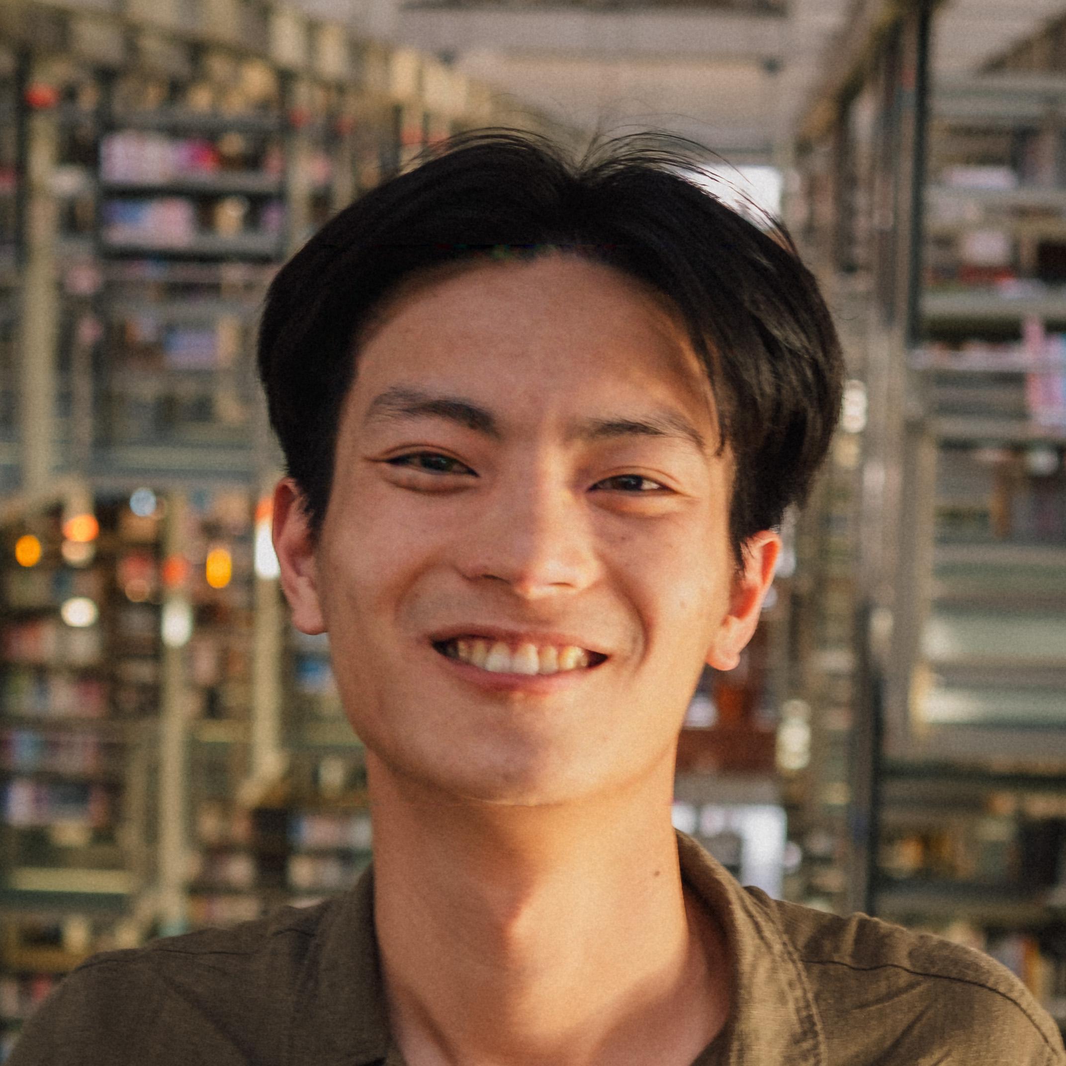 Photo of Paul smiling with bokeh lights in the background